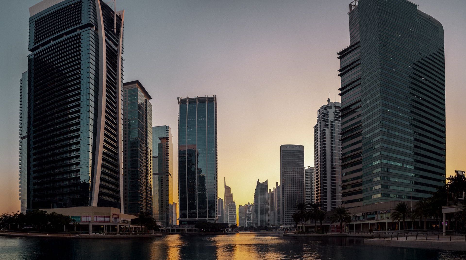 Die Hochhaustürme von Jumeirah Lake Towers rund um die künstlichen Seen bei Abenddämmerung